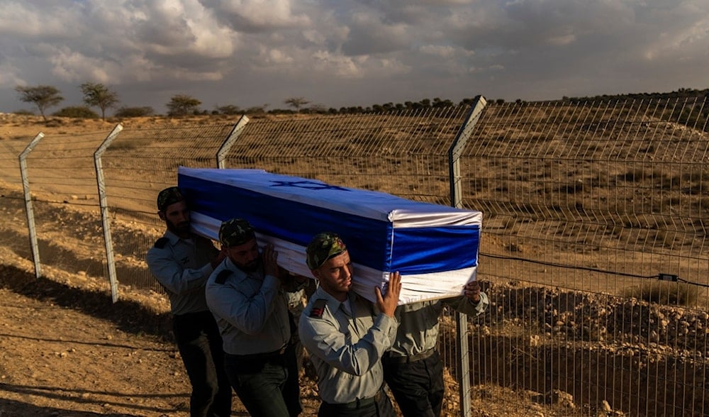 Israeli soldiers carry the coffin of a captain who was killed in Gaza, during his funeral in southern occupied Palestine, Monday, Nov. 18, 2024. (AP)