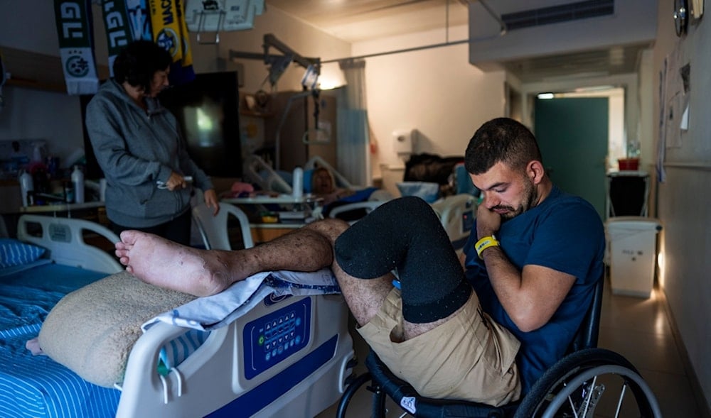 Israeli soldier wounded in the war with Hamas, sits in his room at Sheba hospital's rehabilitation division, in Ramat Gan, occupied Palestine, Monday, Dec. 18, 2023. (AP)