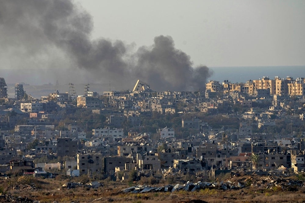 Smoke rises following an explosion in the Gaza Strip as seen from occupied Palestine, Wednesday, Dec.18, 2024. (AP Photo/Ohad Zwigenberg)