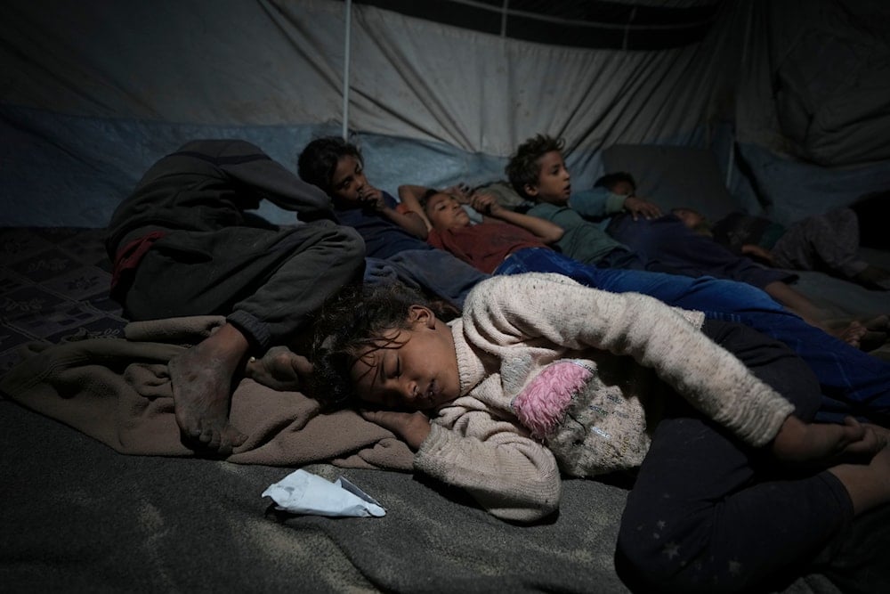 Shireen Daifallah's children, who were displaced from northern Gaza, sleep in their tent at a camp for displaced people in Deir al-Balah. Gaza Strip, on November 30, 2024. (AP)