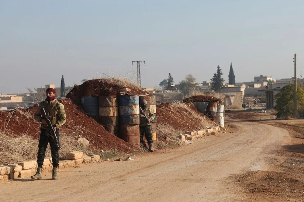 A terrorist stand guard in Kafr Halab, Aleppo countryside, Syria on November 29,2024. (AP)