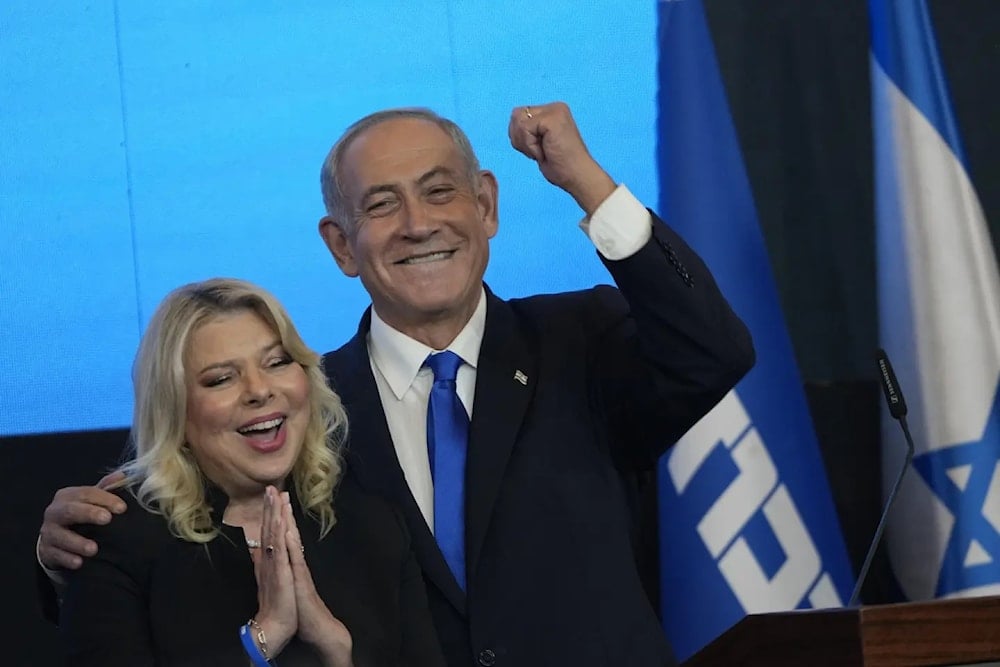 Then-former Israeli Prime Ministe Benjamin Netanyahu and his wife Sara gesture after first exit poll resukts for the Israeli Parliamentary election at his party's headuarters in al-Quds, on November 2, 2022. (AP)