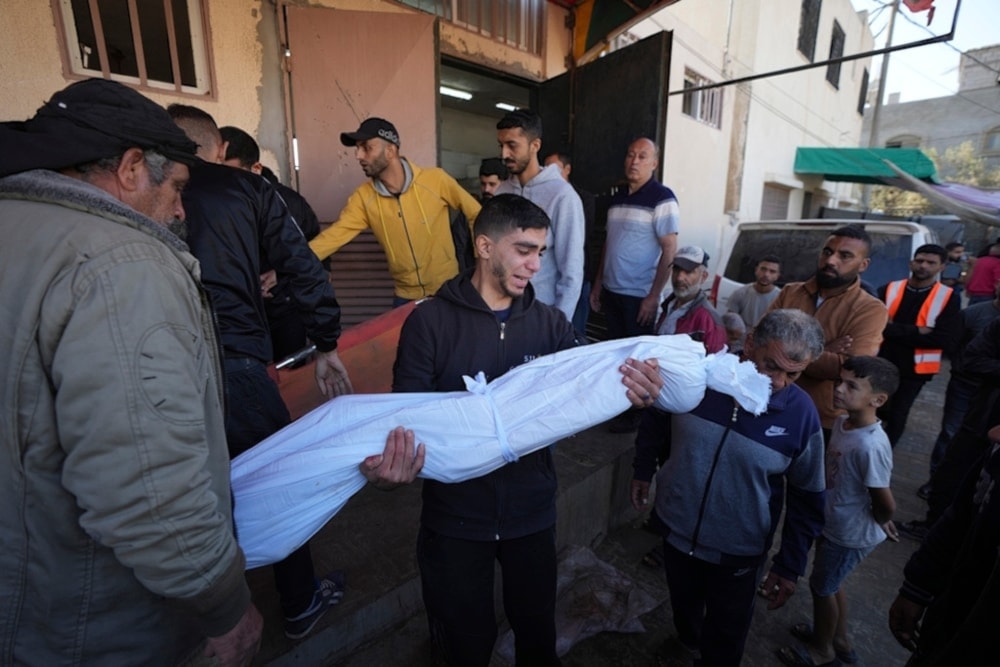    A Palestinian man mourns a child killed in an Israeli airstrike in Bureij refugee camp, Gaza Strip, Friday, November 15,2024. (AP)