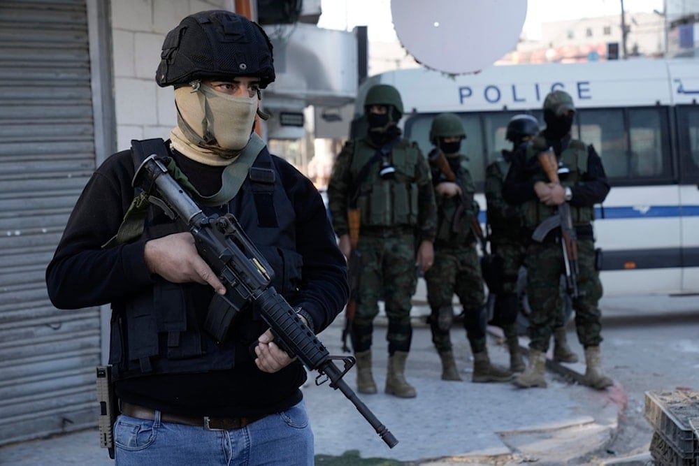 Officer from the Palestinian Authority clutches his gun as Palestinian security forces mount a major raid against Resistance factions in the Jenin camp in the occupied West Bank, Dec. 16, 2024. (AP)