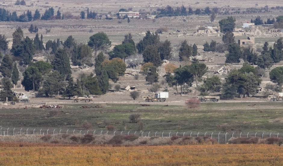 Israeli occupation armored vehicles maneuvering in the buffer zone at the Quneitra crossing between 'Israel' and Syria, observed from the Israeli-occupied Golan Heights on Tuesday, Dec. 10, 2024. (AP)