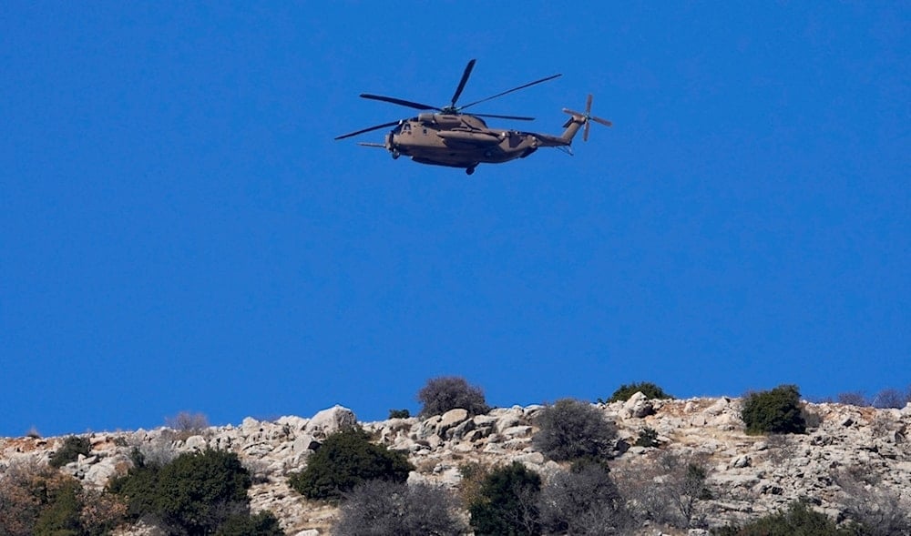 An Israeli occupation Air Force Black Hawk helicopter flies over Mount Hermon near the so-called Alpha Line that separates the Israeli-occupied Golan Heights from Syria, Dec. 17, 2024. (AP)