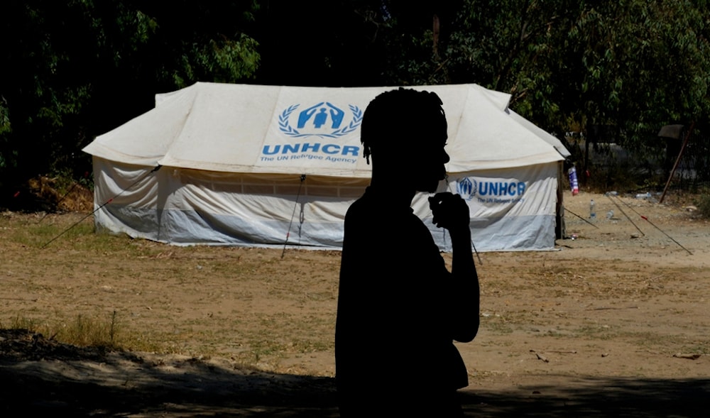 A refugee stands in front of a tent at a camp inside the UN-controlled buffer zone that divides the north part of the Turkish-occupied area from the south Greek Cypriots, Cyprus, Aug 9, 2024. (AP)