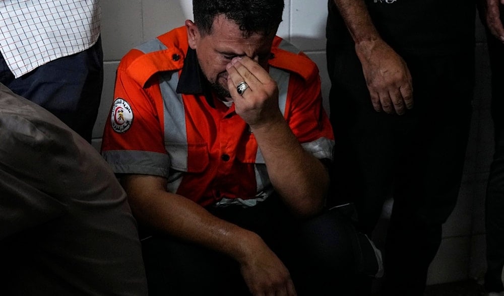 Palestinians mourn their colleague civil defense member killed in the Israeli bombardment of Nuseirat refugee camp, central Gaza Strip, June 27, 2024. (AP)