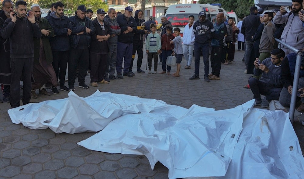 Men pray over the bodies of victims of an Israeli airstrike at the Nuseirat refugee camp during a funeral prayer outside the Al-Aqsa Martyrs hospital in Deir al-Balah, Gaza Strip, Saturday Dec. 21, 2024. (AP)