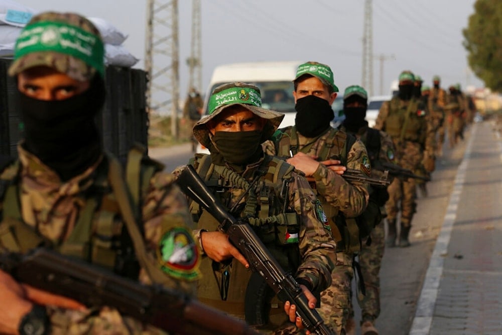 Members of al-Qassam Brigades, a military wing of Hamas, march with their rifles along the main road of Nusseirat refugee camp, central Gaza Strip, Palestine, Oct. 28, 2021. (AP)