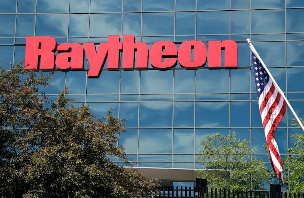 An American flag flies in front of the facade of Raytheon's Integrated Defense Systems facility, in Woburn, Mass on June 10, 2019. (AP)