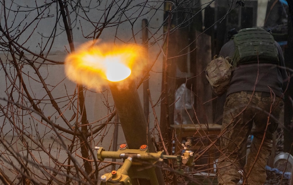 A Ukrainian serviceman of the 57th Mechanised Brigade fire 120mm mortar towards Russian positions near Kharkiv, Ukraine, Tuesday, December 24, 2024 (AP)