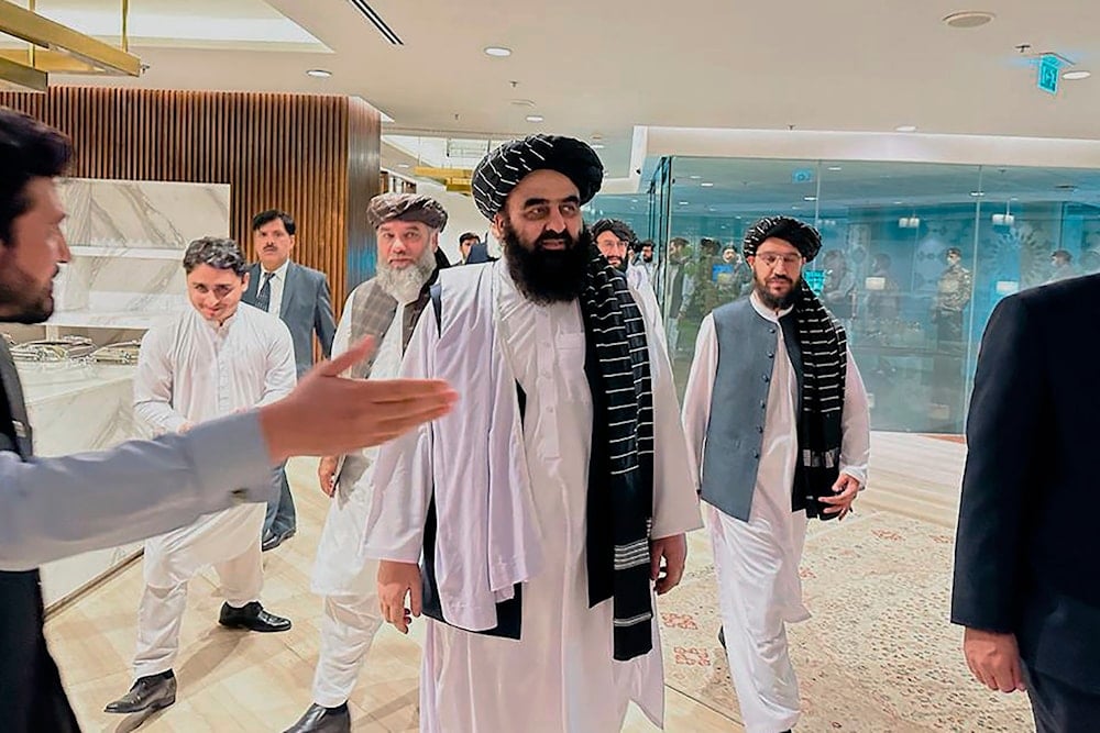 In this photo provided by Afghanistan Embassy in Pakistan, the Taliban-appointed Foreign Minister Amir Khan Muttaqi, center, walks with other officials upon his arrival in airport, in Islamabad, Pakistan, Friday, May 5, 2023. (AP)