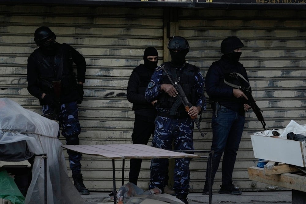 Officers from the PA clutch their guns as Palestinian security forces mount a major raid against militants in the Jenin refugee camp in the Israeli-occupied West Bank, Dec. 16, 2024. (AP)