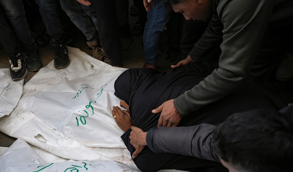 A relative mourns over the body of one of the five Palestinian journalists who were killed by an Israeli airstrike in Gaza City at the Al-Aqsa Hospital in Deir al-Balah, Thursday, Dec. 26, 2024. (AP)