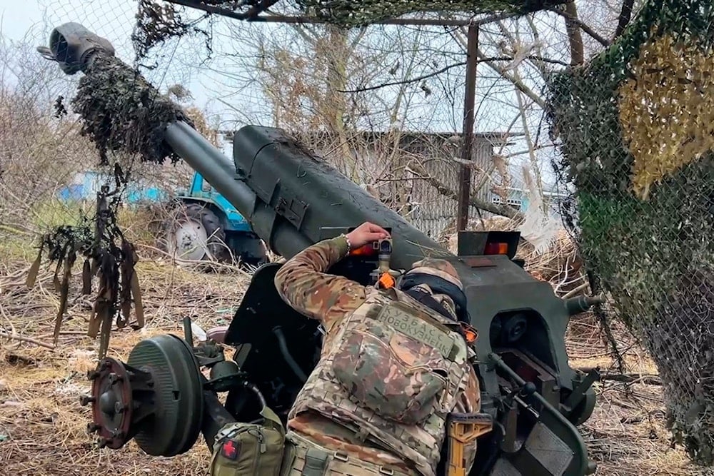 In this photo taken from a video released by the Russian Defense Ministry press service on Friday, November 29, 2024, a Russian serviceman aims a D-30 howitzer toward Ukrainian positions in the border area of Kursk region, Russia (AP)