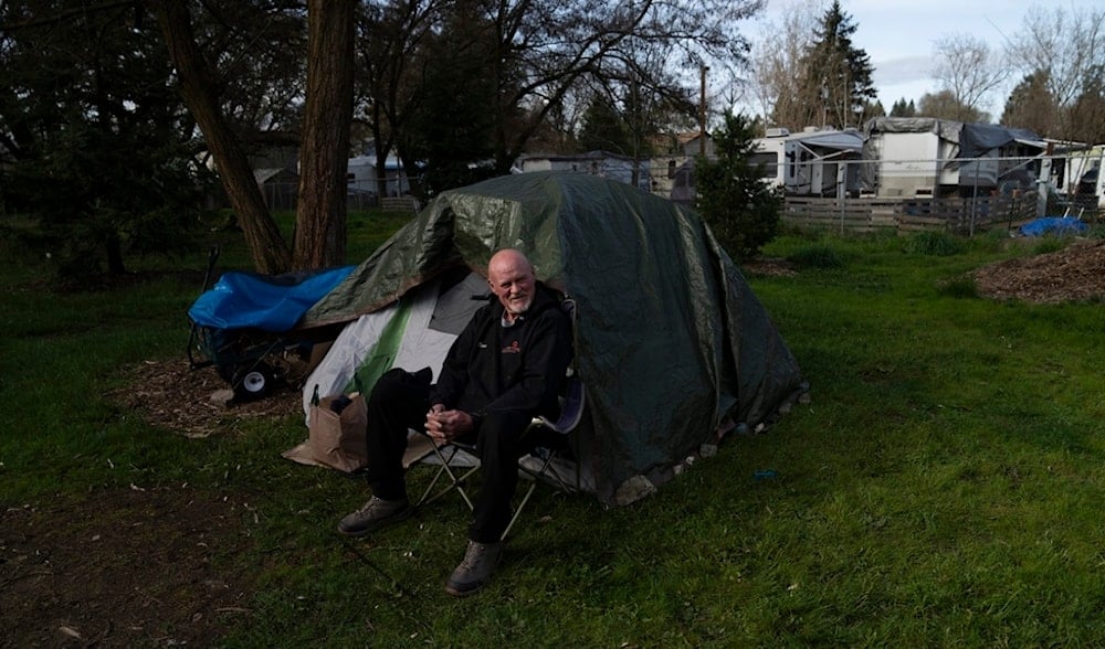 David Wilson sits outside his tent at Riverside Park on Thursday, March 21, 2024, in Grants Pass, Ore. (AP)