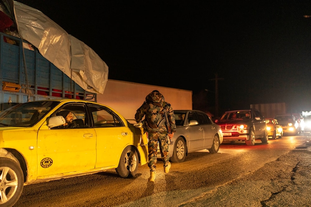 A member of the security forces of the newly formed Syrian government stands on guard at a security checkpoint on the Syrian border with Lebanon, Friday, December 27, 2024 (AP)