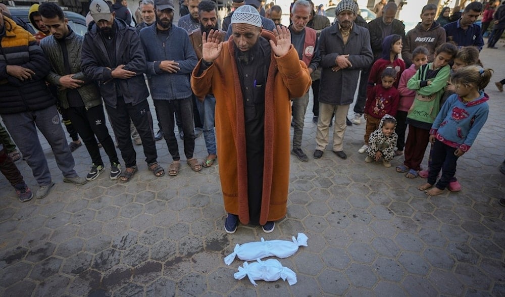 Imam Islam Abu Suaied prays over the bodies of two babies before their burial at the Al-Aqsa Martyrs Hospital in Deir al-Balah, central Gaza Strip, Sunday, Dec. 29, 2024. (AP)