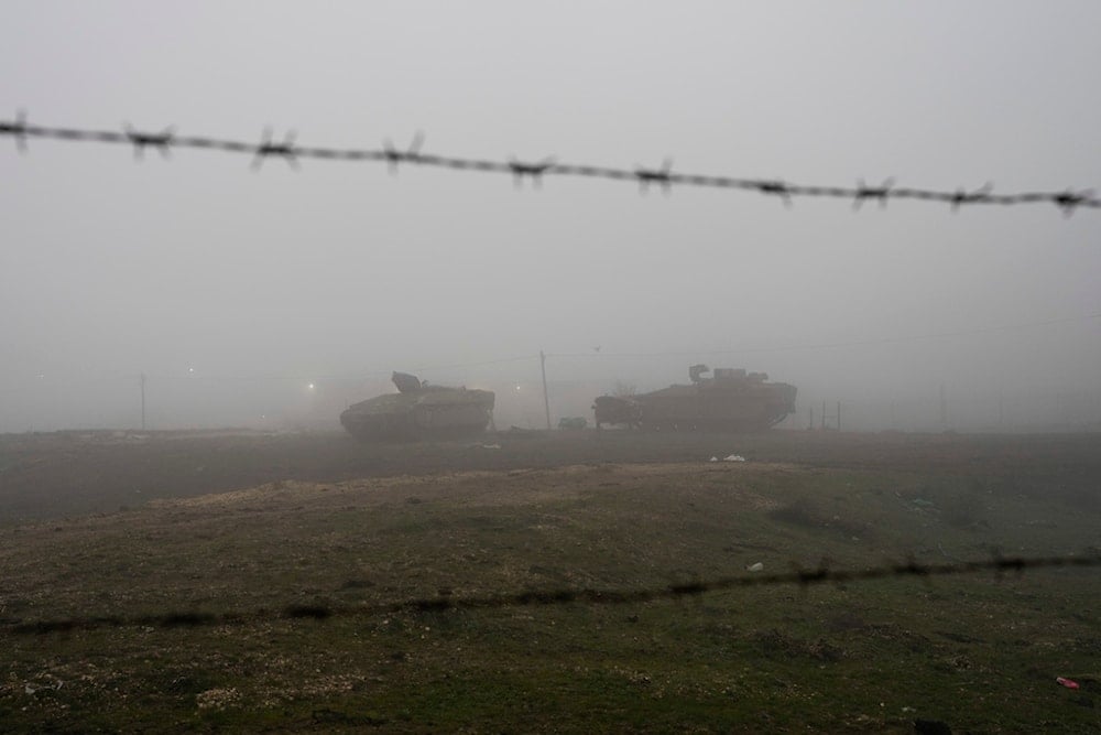 Israeli armored vehicles park on the side of a road in the Israeli-controlled Golan Heights, on Sunday, December 22, 2024 (AP)