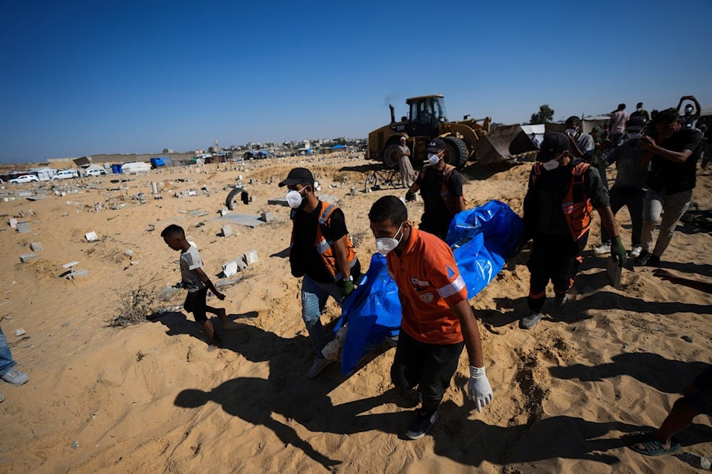 People bury the bodies of Palestinians taken by the Israeli military during operations in Gaza and returned this week, in Khan Younis, Gaza Strip, on September 26, 2024. (AP)