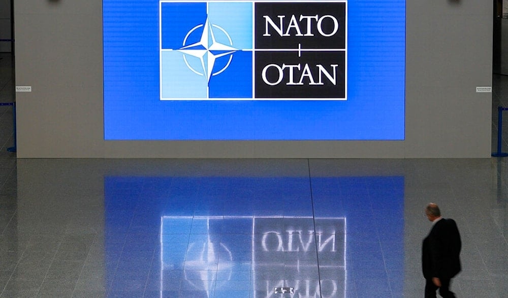 A man walks in the lobby of the NATO headquarters, Wednesday, Nov. 16, 2022 in Brussels. (AP)