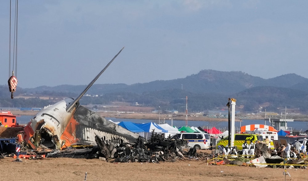 Rescue team members work at the site of a plane fire at Muan International Airport in Muan, South Korea, Monday, Dec. 30, 2024. (AP)