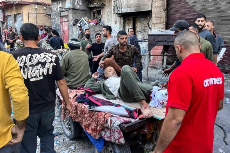  A man who was injured during Israeli bombardment on Beit Lahia, in the northern Gaza Strip, is placed on a cart on 4 Nov 2024 [AFP]