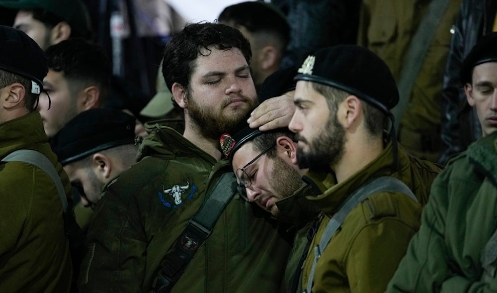 People attend the funeral of 1st Sgt. Yuval Shoham, who was killed in a combat in the Gaza Strip, at Mount Herzl military cemetery in al-Quds, Monday, Dec. 30, 2024. (AP)