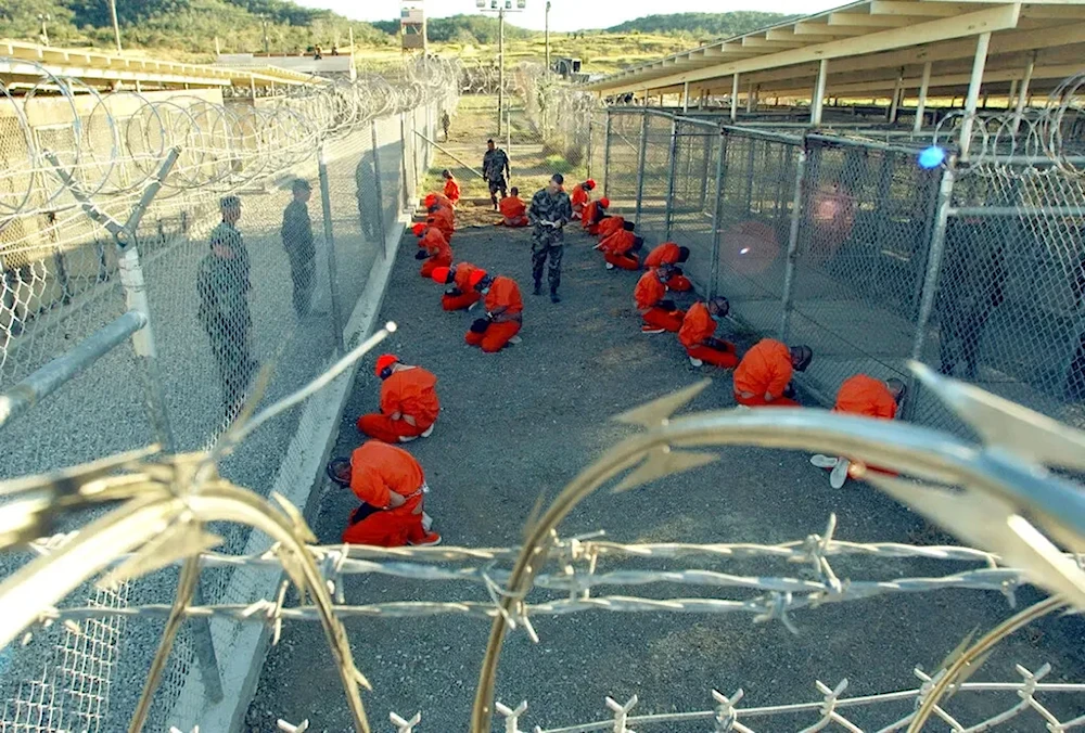 An image taken by the U.S. military on Jan. 11, 2002, showing the first prisoners at Guantánamo Bay, Cuba, soon after their arrival.(Petty Officer First Class Shane T. McCoy/U.S. Navy)