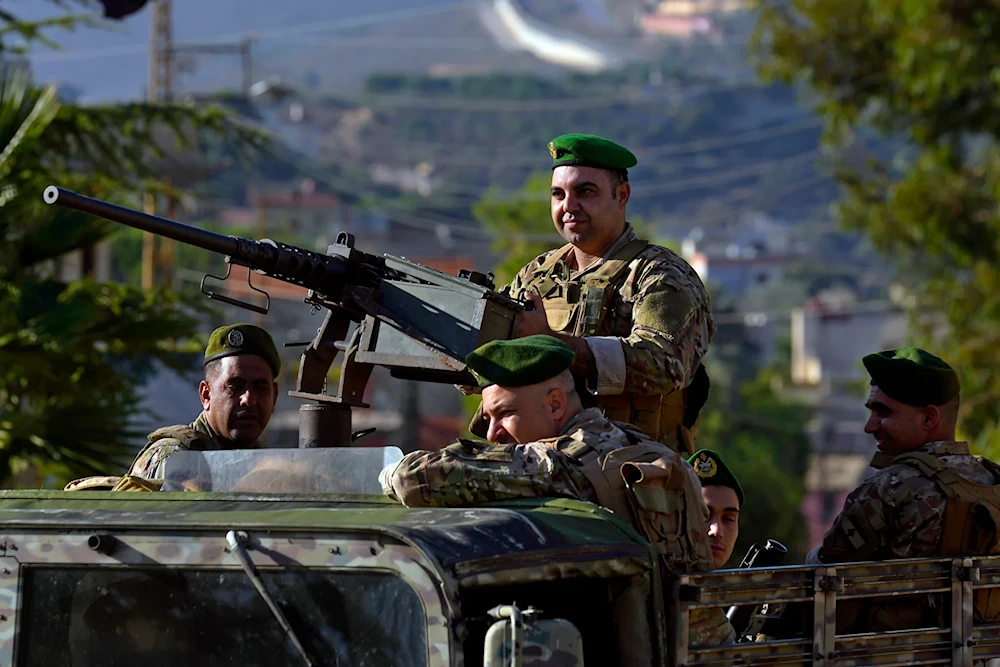 Lebanese army soldiers sit on their armored vehicle as they patrol the Lebanese side of the Israel-Lebanon border in the southern village of Kfar Kila, Lebanon, on October 13, 2023. (AP)