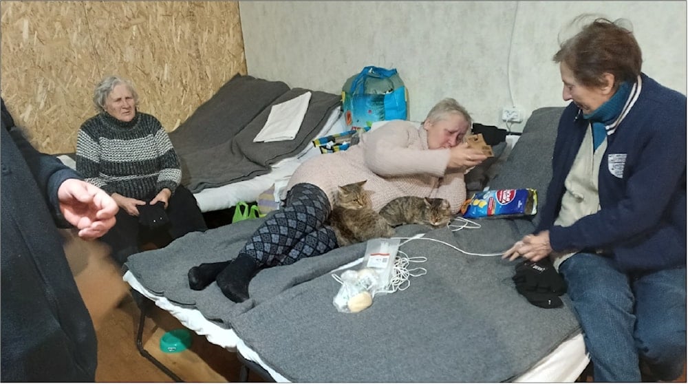 Residents (and their cats) at a makeshift centre for refugees, Avdeevka