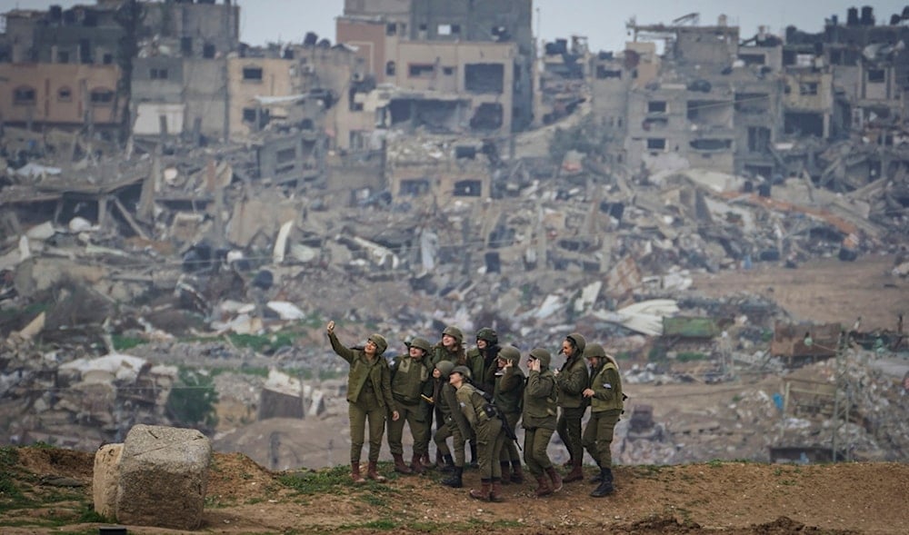 Israeli soldiers pose for a photo at the edge with the besieged Gaza Strip,vPalestine, on Feb. 19, 2024. (AP)