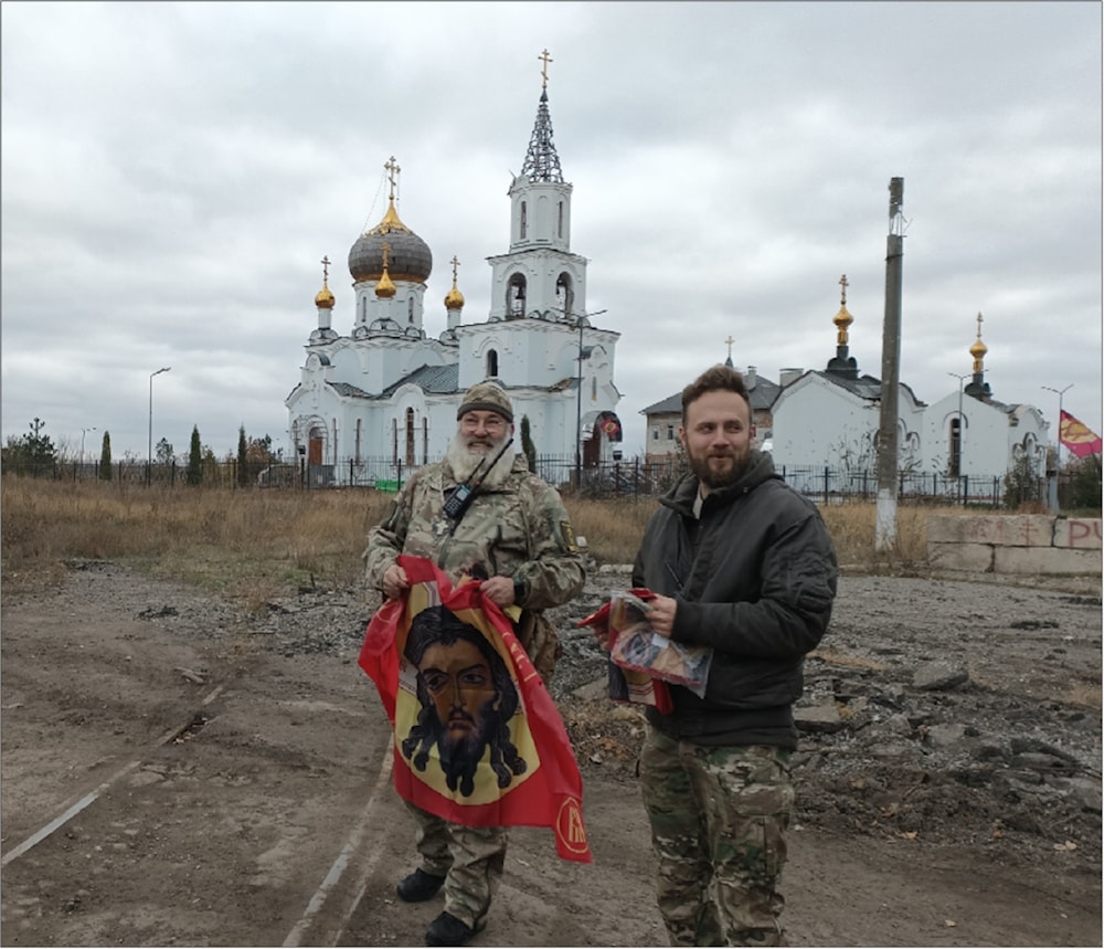 Father Svyatoslav and Andrey outside the Church of St. Mary Magdalene in Avdeevka