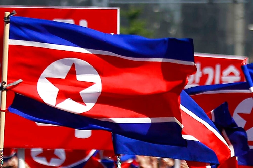 DPRK flags are carried during a celebration of the nation's 73rd founding anniversary in Pyongyang, DPRK on Sept. 9, 2021. (AP)