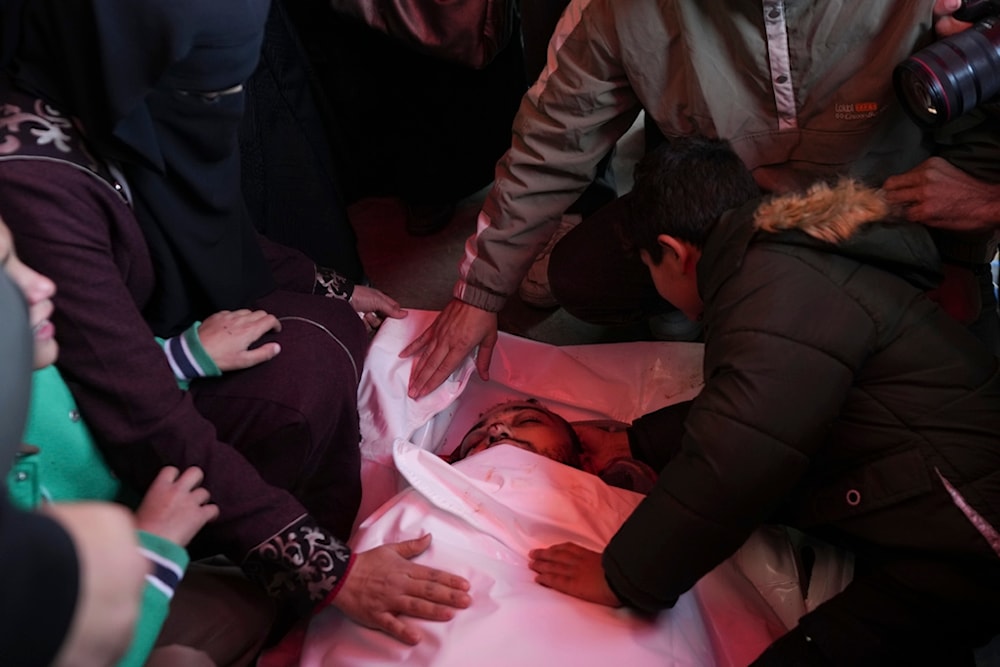 Palestinians mourn over the body of victim of an overnight Israeli strike, during a funeral in Deir al-Balah, Gaza Strip, Wednesday, Dec. 4, 2024. (AP)