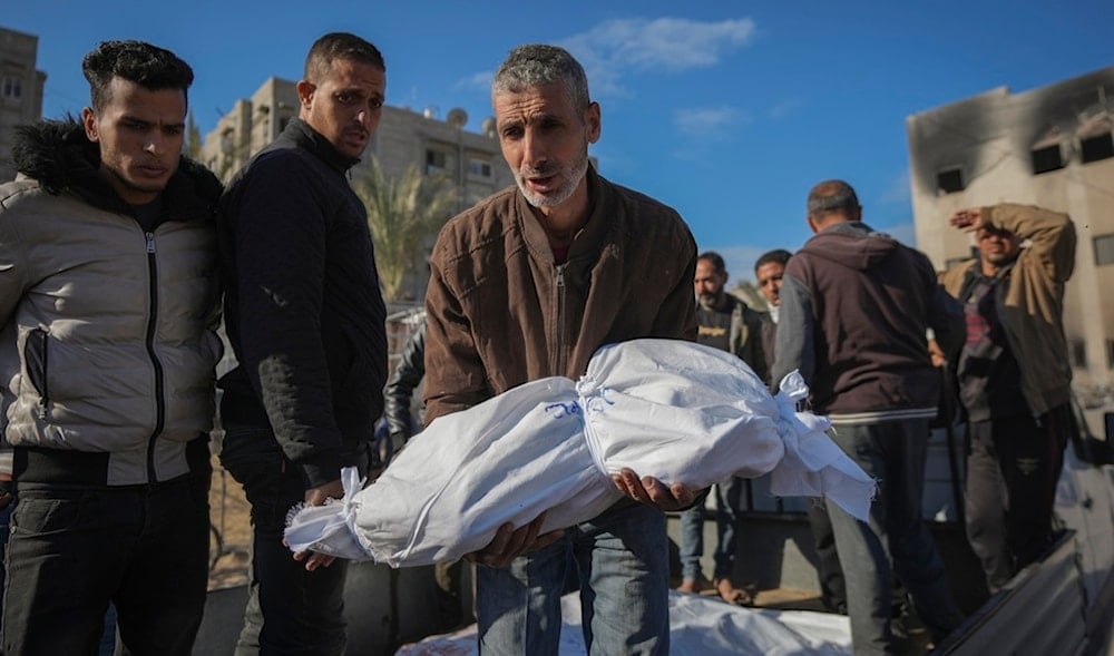 The body of 18-month-old Sham Shurrab is carried by her uncle for burial in the aftermath of an Israeli airstrike at the al-Mawasi camp in Khan Younis, southern Gaza Strip, Thursday, Dec. 5, 2024. (AP)