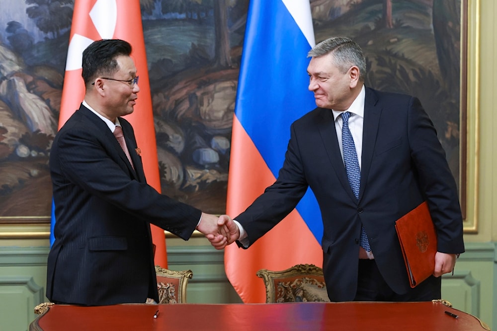 Deputy FM Andrei Rudenko, right, and his counterpart Kim Jong Gyu shake hands as they sign a protocol on exchanging instruments of ratification in Moscow, Russia, Dec. 4, 2024. (AP)