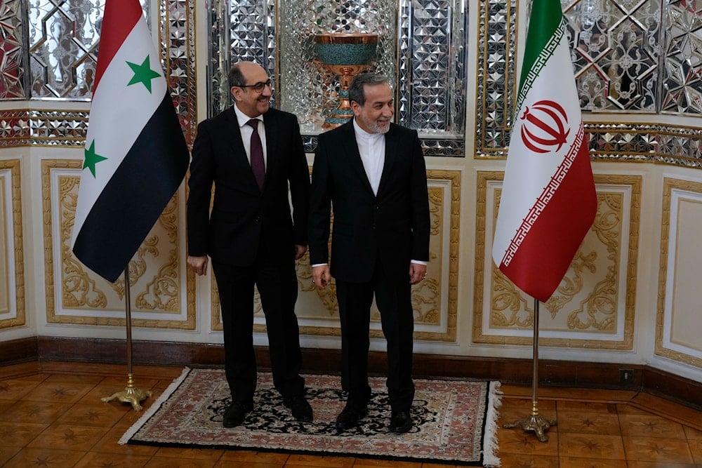 Syrian Foreign Minister Bassam Sabbagh, left, is welcomed by his Iranian counterpart Abbas Araghchi as they wait for the Syrian delegation prior to their meeting in Tehran, Iran, on November 19, 2024. (AP)