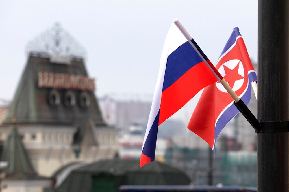 Flags of Russia and North Korea are seen in front of the central railway station in Vladivostok, Russia, Wednesday, April 24, 2019. (AP)