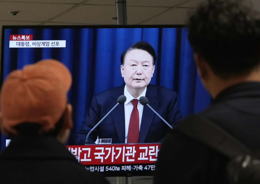 People watch a TV screen showing South Korean Presdienr Yoon Suk Yeol's televised briefing at a bus terminal in Seoul, South Korea on December 3,2024. (AP)