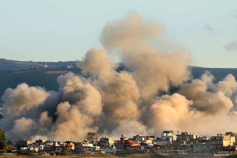 Smoke rises between buildings hit in Israeli airstrikes near the Palestinian refugee camp of Rashidiyeh, as seen from Tyre city, south Lebanon, Tuesday, Nov. 26, 2024. (AP)