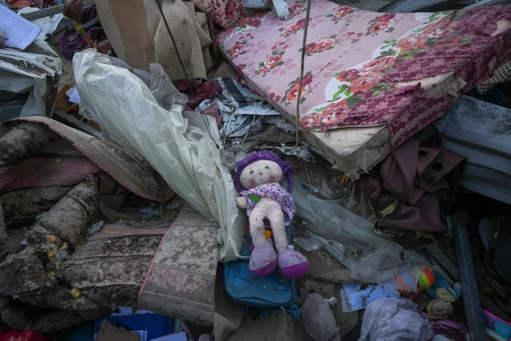 A doll lies among debris in the after math of an Israeli airstrike at the Muwassi camp near Khan Younis in the southern Gaza strip, on Thursday, December 5, 2024. (AP)
