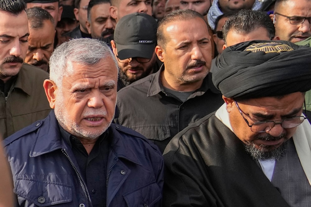 Leader of the Badr Organization, Hadi al-Amiri, left, attends a funeral for the group members who were killed by a US air strike, in Baghdad, Iraq, Sunday, February 4, 2024 (AP)