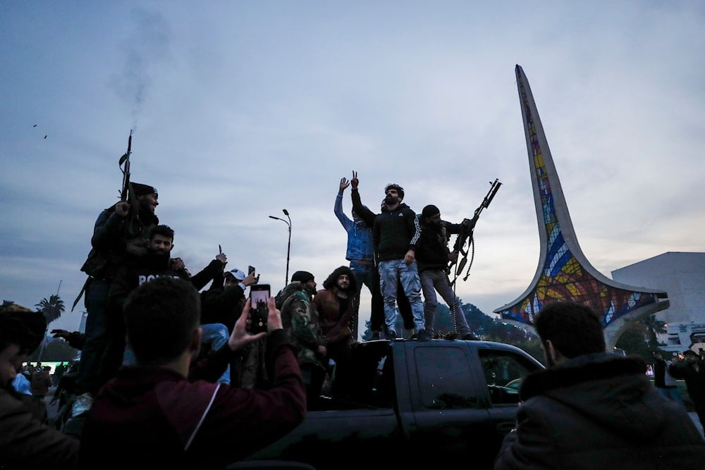 Syrians shoot in the air in celebration of the arrival of opposition fighters in Damascus, Syria, on December 8, 2024. (AP)