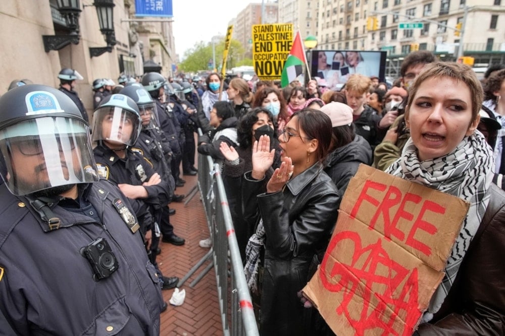 Police in riot gear stand guard as pro-Palestinian demonstrators chant slogans outside the Columbia University campus, Thursday, April 18,2024, in New York, US. (AP)