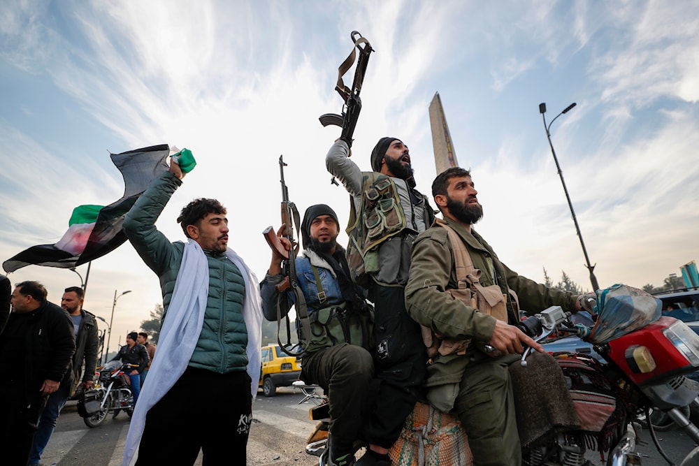 Syrian opposition fighters celebrate after the Syrian government collapsed in Damascus, Syria, on December 8, 2024. (AP)