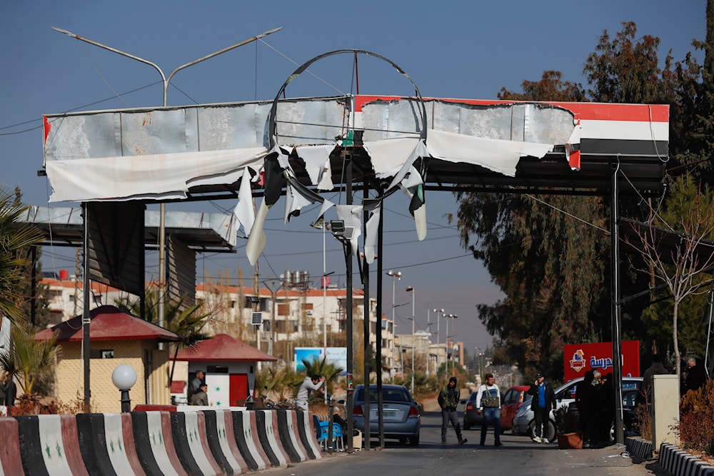 Syrian opposition fighters man a checkpoint in Damascus, Syria, on December 9, 2024. (AP)