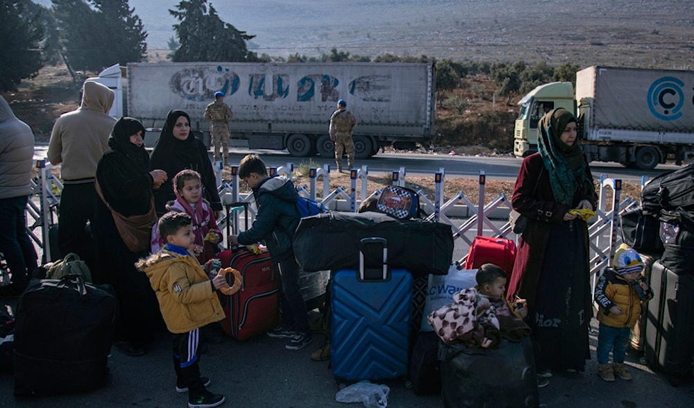 Syrian families wait to cross into Syria from Turkey at the Cilvegozu border gate, near the town of Antakya, southern Turkey, Monday, Dec. 9, 2024. (AP)