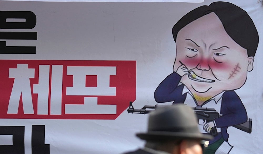 A caricature depicting South Korean President Yoon Suk Yeol is seen near the ruling People Power Party's head office in Seoul, South Korea, Dec. 9, 2024. The letters read 